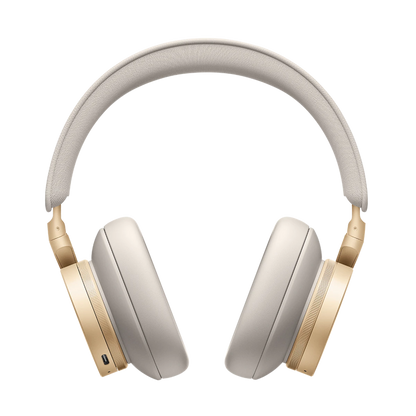 Beoplay H95 hovedtelefoner i beige og guld på hvid baggrund