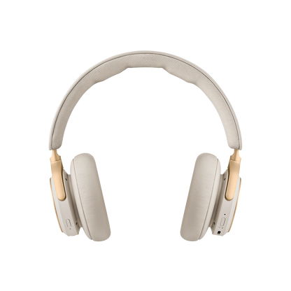 Beoplay HX trådløse hovedtelefoner i beige farve med gulddetaljer på hvid baggrund